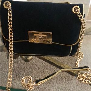 Used Michael Kors black and gold purse